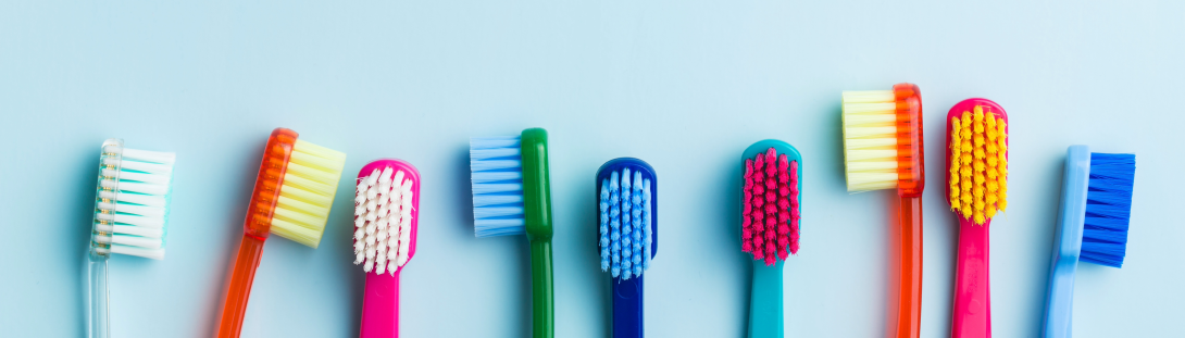 row of toothbrushes on blue background