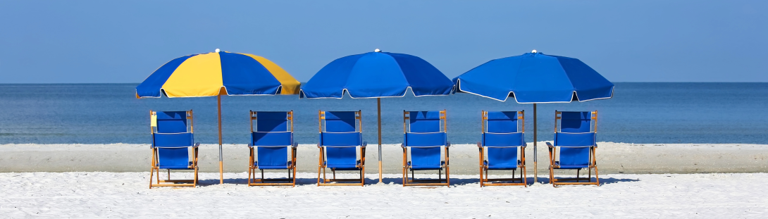 Blue and Yellow umbrellas with chairs on a beach