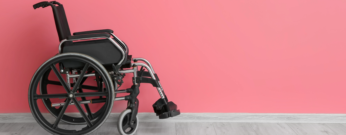 Wheelchair on pink background