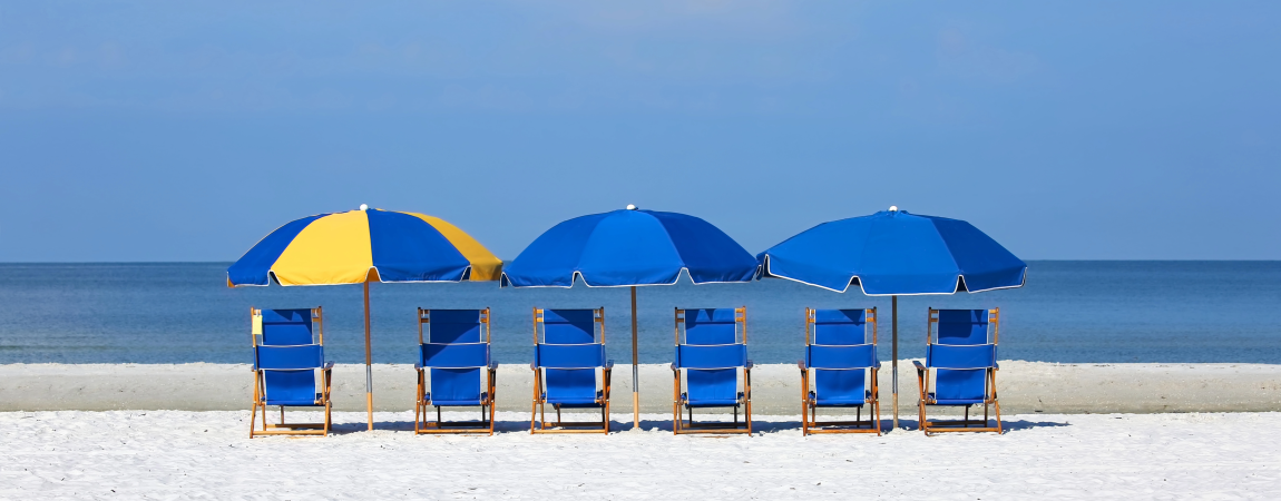 Blue and Yellow umbrellas with chairs on a beach